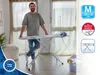 A man stands behind an ironing board in a room with large windows. Náhľad obrázku produktu