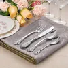 A table setting with cutlery, plates, and flowers. Produktbild-Vorschau