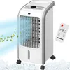A white and gray Syntrox Germany air cooler with a remote control, shown with a blue air flow and green leaves illustration, and ice cubes at the bottom.