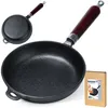 A cast iron frying pan with a wooden handle is shown, along with its packaging. Náhľad obrázku produktu