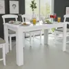 A white dining table with chairs and place settings in a room with a large window. Anteprima dell’immagine prodotto