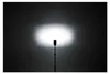 A studio shot of a camera flash on a stand, illuminating a dark background. Podgląd zdjęcia produktu