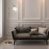 A floor lamp and sofa in a living room. Produktbild-Vorschau