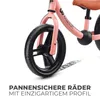 Close-up of a pink balance bike wheel and frame with text overlay. Náhled obrázku produktu