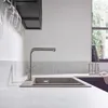 A modern kitchen sink with a faucet running water. Produktbild-Vorschau