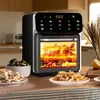 An air fryer oven is shown on a kitchen counter, cooking a whole chicken and vegetables. Plates of fries and cauliflower are in the foreground. Náhľad obrázku produktu