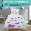 A child's bedding set with a butterfly motif is displayed on a bed in a bedroom setting. Produktbild-Vorschau