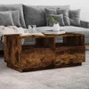 A wooden coffee table with storage is placed in front of a grey sofa in a living room setting. Náhled obrázku produktu