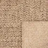 A close-up view of a woven rug with a textured pattern. Produktbild-Vorschau