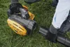 Two people assembling a leaf blower in a grassy area. Produktbild-Vorschau