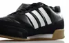 A close-up, side view of a black Adidas sneaker with white stripes. Anteprima dell’immagine prodotto