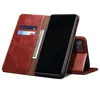 A brown leather flip wallet case for a smartphone is shown open, with cards and cash inserted. Produktbild-Vorschau