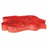 A red Theraband CLX fitness band is coiled and laid out on a white background. Produktbild-Vorschau