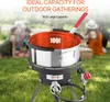 A propane fryer set up outdoors on grass, with people in the background. Produktbild-Vorschau