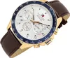 A close-up, angled shot of a Tommy Hilfiger men's watch with a white dial, gold casing, and brown leather strap, set against a white background. Anteprima dell’immagine prodotto
