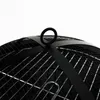 A close-up view of the top of a black metal fire pit, showing the mesh dome and a carrying handle. Náhľad obrázku produktu