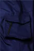 A close-up view of a dark blue cargo pocket with a zipper on a pair of pants. Produktbild-Vorschau
