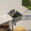 An outdoor sink setup with a marble-effect countertop and a tiled patio. Anteprima dell’immagine prodotto
