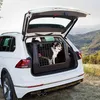 A white car with its trunk open, containing a dog in a carrier, parked in a scenic outdoor location. Anteprima dell’immagine prodotto