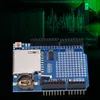 A blue electronic module with an SD card slot and a battery holder, set against a dark background with a green digital graph overlay. Náhled obrázku produktu