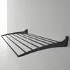 A black metal wall-mounted drying rack is shown against a light gray and white background. Produktbild-Vorschau