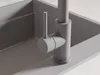 A close-up view of a modern gray kitchen faucet installed in a gray sink. Produktbild-Vorschau