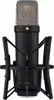 A studio shot of a black Rode NT1 microphone with a silver grille, mounted in a black shock mount. Podgląd zdjęcia produktu