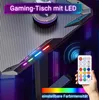 A gaming desk with LED lighting, a remote control, and a colorful light spectrum. The background is dark and abstract with vertical lines of light. Voir les images du produit