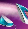 A close-up shot of a steam iron system, showing the iron releasing steam against a purple background. Voir les images du produit