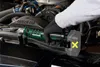 A person wearing gloves is using a cordless angle impact wrench in the engine bay of a car. Náhled obrázku produktu
