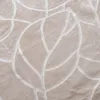 A close-up view of a textured beige fabric with a raised pattern. Podgląd zdjęcia produktu