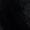 A close-up, textured view of a black shaggy rug. Voir les images du produit