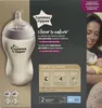 The image shows the packaging of Tommee Tippee baby bottles, with a close-up of one bottle and a mother feeding a baby in the background. Produktbild-Vorschau