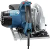 A close-up, angled view of a blue and silver circular saw with a black handle and cord. Podgląd zdjęcia produktu