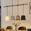 A dining table with chairs and a pendant light fixture. Produktbild-Vorschau