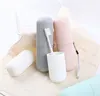 Several toothbrush holders in different colors are arranged on a light-colored cloth, with a white basket in the background. Produktbild-Vorschau