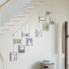 A staircase wall decorated with a series of hanging picture frames. Podgląd zdjęcia produktu