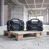 Two Bosch Professional radios are placed on a wooden pallet in a construction site. Produktbild-Vorschau