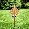 A solar-powered garden stake shaped like a fairy is planted in a grassy lawn. Produktbild-Vorschau
