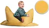 A child sits on a yellow beanbag chair. Produktbild-Vorschau