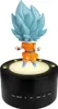 A Goku figurine with blue hair and orange clothing stands on a black illuminated base. Voir les images du produit