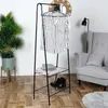 A clothes rack with clothes and shoes is set up in a room. Náhled obrázku produktu