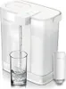 A white Philips water filter pitcher is shown with water being dispensed into a glass. A replacement filter is also shown next to the pitcher. Náhled obrázku produktu