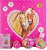 A pink advent calendar with a heart-shaped window revealing two horses, surrounded by decorative elements and small product samples. Produktbild-Vorschau