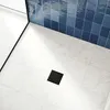 A close-up view of a shower drain in a tiled bathroom. Produktbild-Vorschau