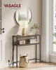 A narrow console table with two shelves, a lamp, books, a radio, and a basket, placed in a hallway next to a door and a window. Produktbild-Vorschau