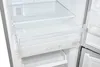 Interior view of a refrigerator with clear drawers and shelves. Produktbild-Vorschau