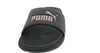 A black Puma slide sandal with a rose gold Puma logo. Produktbild-Vorschau