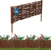 A woven willow fence section with a "Made in EU" tag, shown above a lower section of similar fencing with pink flowers and green foliage. Voir les images du produit
