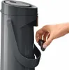 A hand is shown inserting a small black component into a gray dispenser. Anteprima dell’immagine prodotto